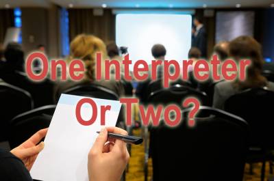 Person taking notes in conference room, with text "One Interpreter Or Two?"