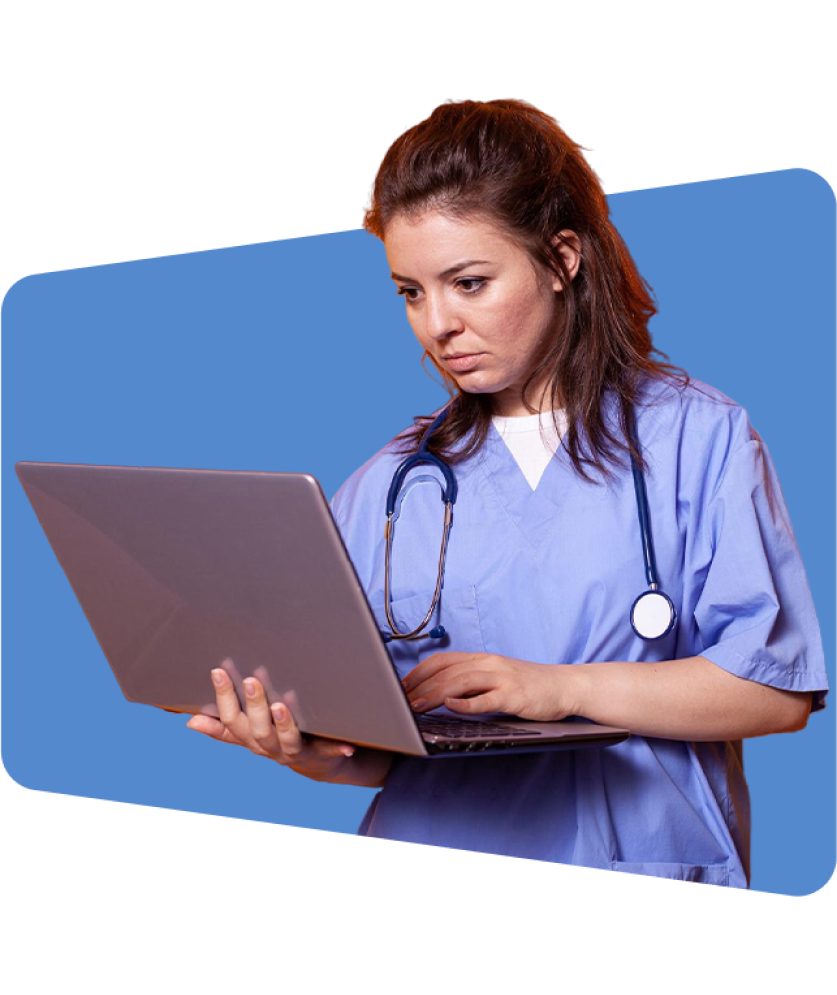 Nurse in blue scrubs using laptop, stethoscope visible, against blue background.