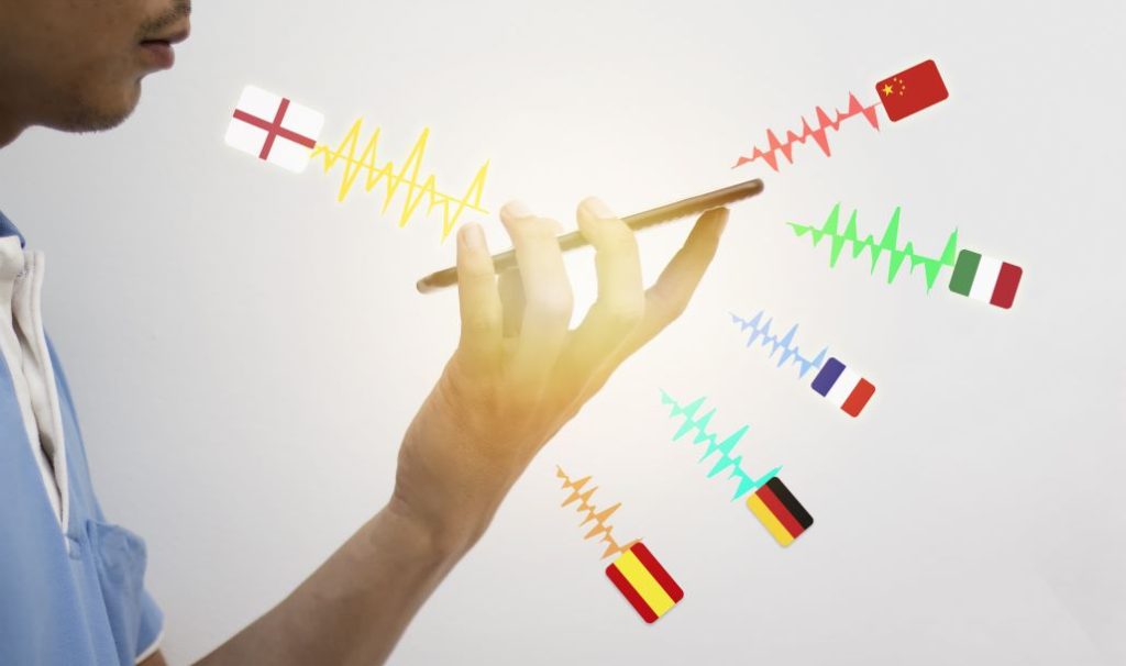 Person using smartphone with colorful sound waves and various national flags.