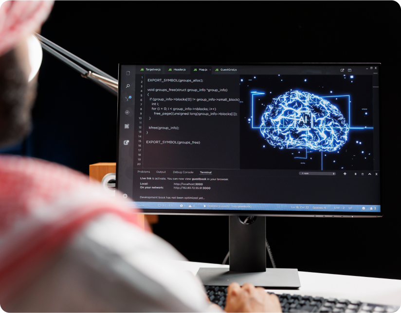 Person viewing computer screen with AI brain graphic and code, photo.