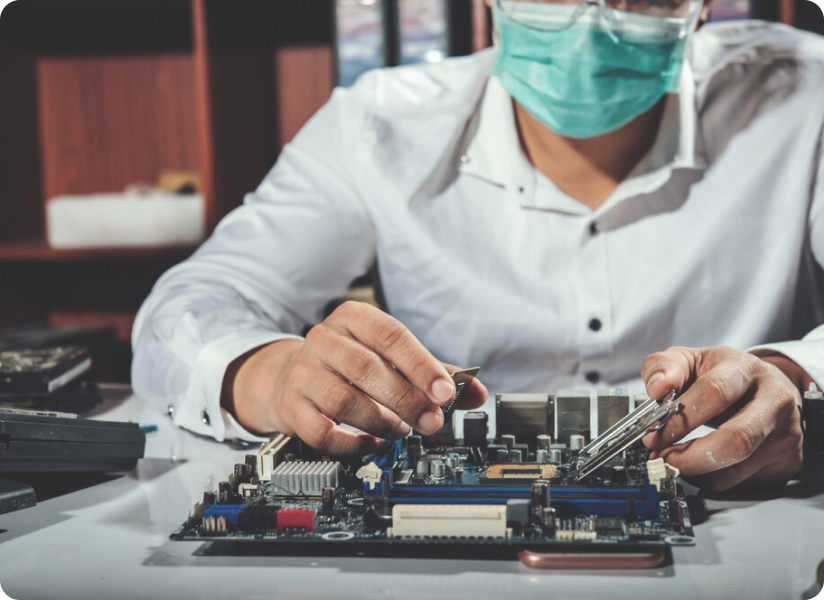 Person in white shirt, mask, assembling computer parts, photo, no text.