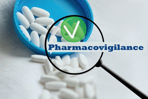 White pills in blue lid with "Pharmacovigilance" text, magnifying glass overlay.